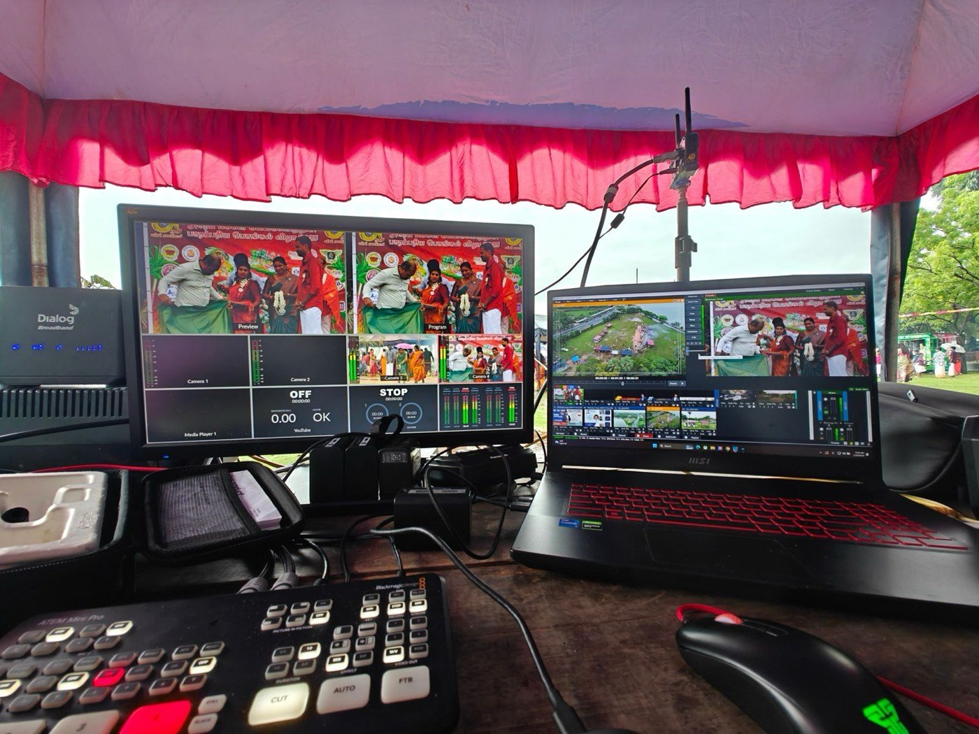 Control desk at the Traditional Pongal Festival 2025: ATEM Mini Pro switcher, multiview monitor showing four cameras, and a laptop with the drone feed