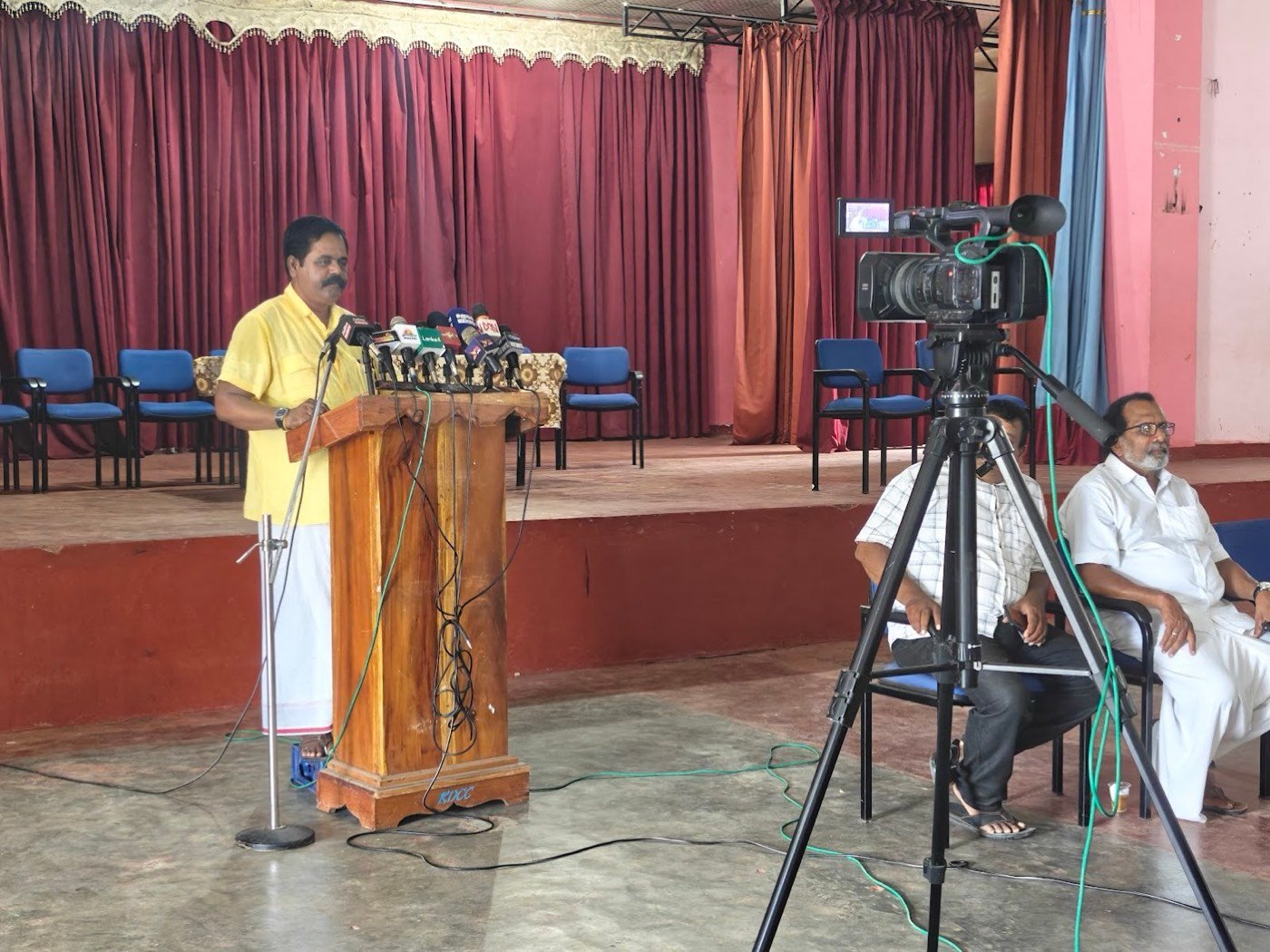 A press conference filmed on a tripod camera